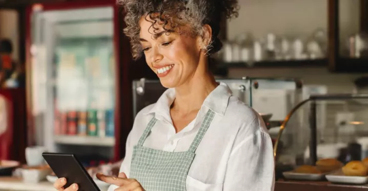 Empreendedora confere o fluxo de vendas em seu estabelecimento. Veja no infográfico como começar a empreender.