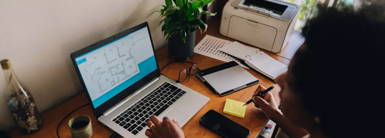 Mulher trabalha no escritório que montou em sua casa