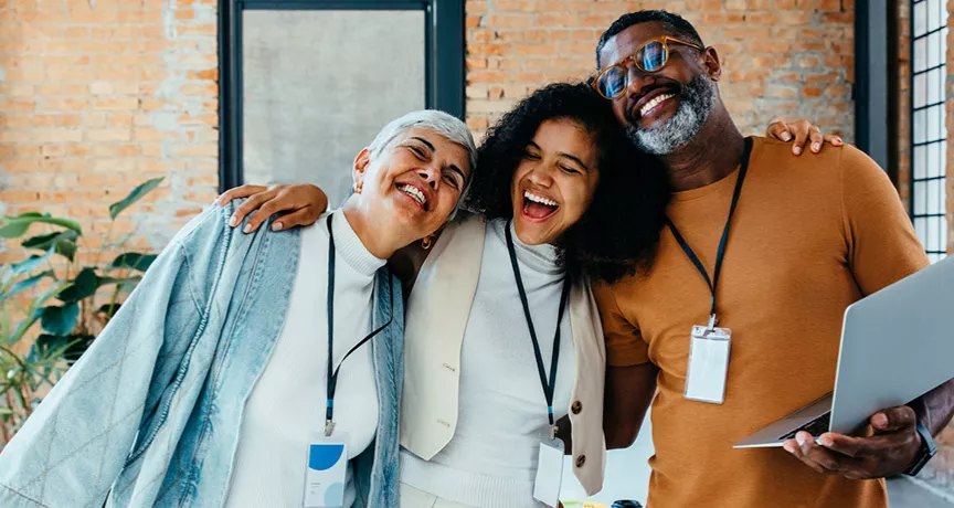 Foto mostra colegas de trabalho felizes durante um dia na empresa