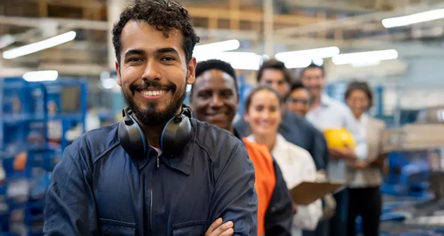 pessoas em fila sorrindo em ambiente de trabalho.