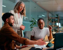 Foto mostra uma equipe fazendo reunião de trabalho numa sala