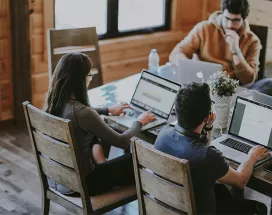 Foto mostra um grupo de pessoas trabalhando em um escritório