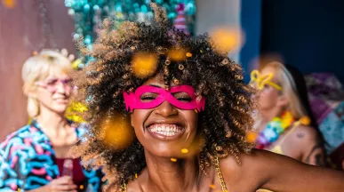Mulher se diverte em festa de Carnaval. Veja como orientar sua equipe sobre segurança no feriado